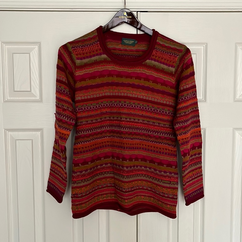 Size large alpaca sweater in red/pink/purple/orange and taupe.
